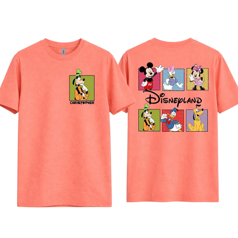 May include: Coral-colored t-shirt featuring Goofy in a green-bordered square on the front, with the name "CHRISTOPHER" below. The back displays Mickey Mouse, Daisy Duck, Minnie Mouse, Goofy, Donald Duck, and Pluto in squares, with "Disneyland" text.