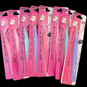 May include: A set of ten pink and purple tweezers with anti-magnetic, anti-acid, and non-corrosive stainless steel construction. The tweezers are labeled "Anti-magnetic, anti-acid and non-corrosive Stainless Steel" and "Magnetic and non-corrosive Stainless Steel".