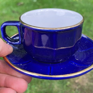 Cup And Saucer Set Of Two Ceramic Round Dark Blue White Golden Details Along Edges Easy Hold Handled Martell Cognac Serving ware Drinkware