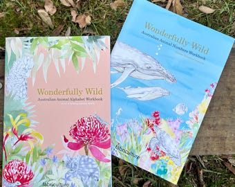 May include: Two workbooks titled "Wonderfully Wild" with Australian animal themes. One has a pink cover with floral and animal illustrations, the other a blue cover with whales and sea life. The "fabriculture" logo is visible on both.
