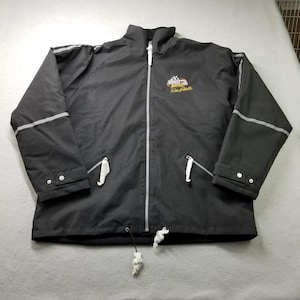 May include: Black zip-up jacket with a high collar and reflective stripes on the sleeves. Features a logo on the chest with the text "Raced 3 Dale Earnhardt". Includes two zippered pockets and a drawstring at the bottom.
