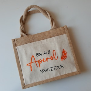 Jutetasche Aperol Spritztour, Tasche Aperol Spritz Tour, Geschenktasche für Getränke, Aperol Spruch in weiß & neon orange schwarz & orange