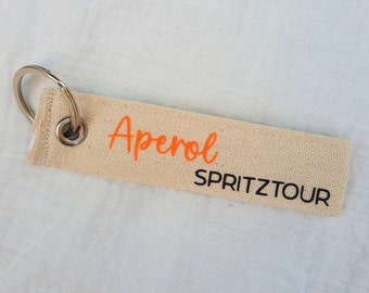 Schlüsselanhänger Aperol Spritztour, Aperol Spruch in schwarz & neon orange, Schlüsselband Aperol Spritz Tour, Anhänger Baumwolle