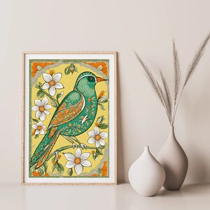 May include: A framed print of a green and orange bird with white flowers on a yellow background.