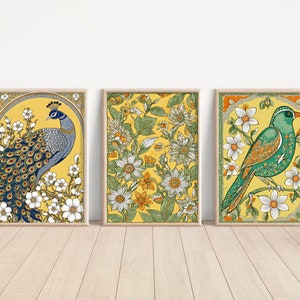 May include: Three framed prints with yellow backgrounds and floral designs. The left print features a blue and green peacock with white flowers. The center print features a floral design with green leaves and white flowers. The right print features a green bird with orange accents and white flowers.