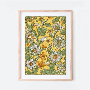 May include: A framed print of a floral pattern with white flowers and green leaves on a yellow background.
