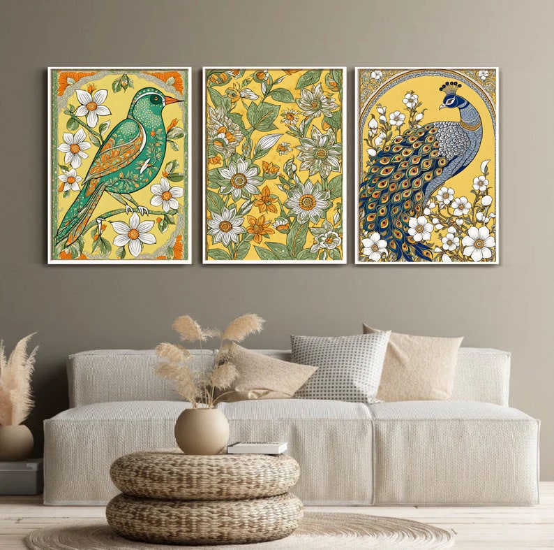 May include: Three framed canvas prints with floral patterns and birds. The left print features a green bird with yellow and white flowers. The center print features a yellow background with green leaves and white flowers. The right print features a blue peacock with white flowers and a yellow background.