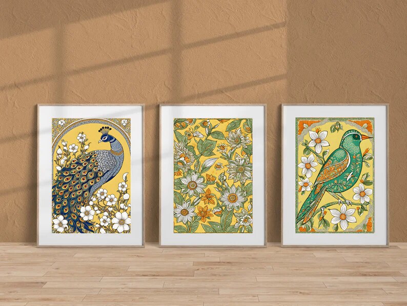 May include: Three framed prints with yellow backgrounds and floral designs. The left print features a blue peacock with a spread tail. The center print features white flowers and green leaves. The right print features a green bird with a white flower in its beak.