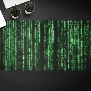 May include: A black and green desk mat with a digital code pattern. The code is in a green font and appears to be scrolling down the screen.