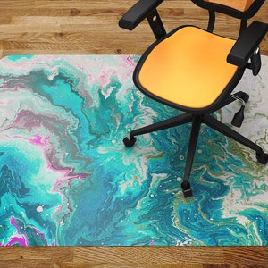 May include: A turquoise, pink, and white abstract marble patterned floor mat with a black office chair on top of it.