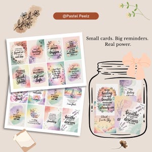 May include: A collection of small cards with inspirational quotes and watercolor designs. The cards are in a glass jar with a bow, and the text reads "Small cards. Big reminders. Real power."