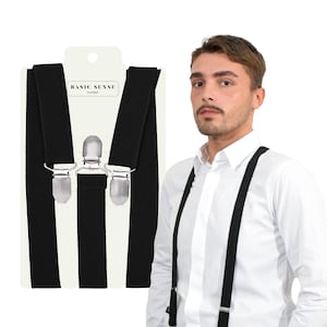 May include: Black braces with silver clips. The braces are shown on a white background and on a person wearing a white shirt.