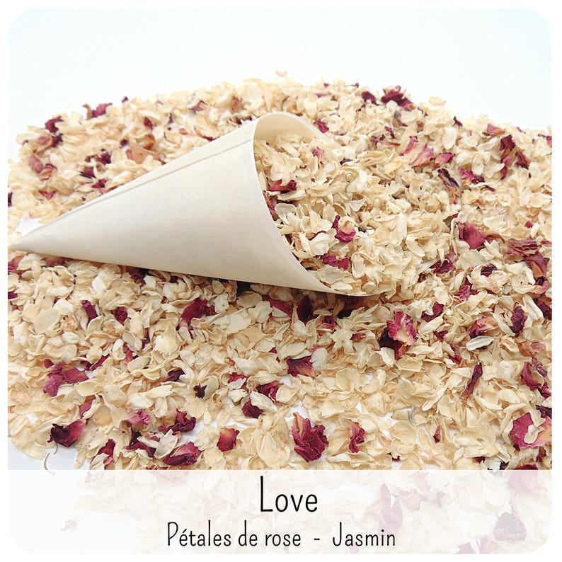 May include: A light-coloured paper cone filled with a mixture of dried cream-coloured jasmine blossoms and deep pink rose petals. The text "Love" and "P&eacute;tales de rose - Jasmin" is printed at the bottom of the image in a simple black font.