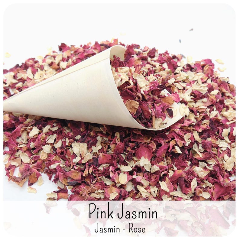 May include: A light beige paper cone filled with a mixture of dried deep pink rose petals and small cream-coloured jasmine flower buds. The text "Pink Jasmin" and "Jasmin - Rose" is printed in black at the bottom of the image over the petals.