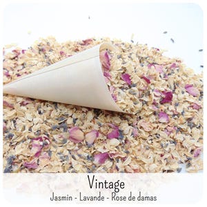 May include: A light-coloured paper cone filled with a mixture of dried flower petals, including pink rose petals, small purple lavender buds, and cream-coloured jasmine blossoms. The text "Vintage" and "Jasmin - Lavande - Rose de damas" is visible.