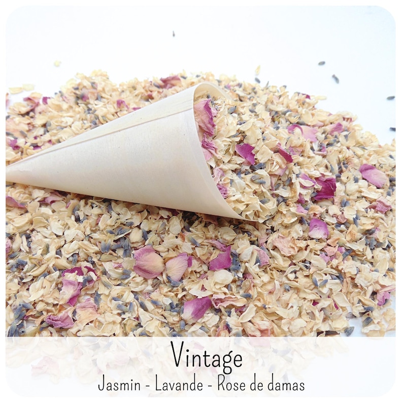 May include: A light-coloured paper cone filled with a mixture of dried flower petals, including pink rose petals, small purple lavender buds, and cream-coloured jasmine blossoms. The text "Vintage" and "Jasmin - Lavande - Rose de damas" is visible.