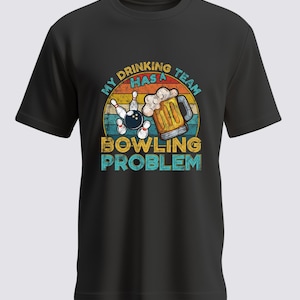 Könnte beinhalten: Schwarzes T-Shirt mit einem Grafikdesign, das eine Bowlingkugel, Kegel und einen Bierkrug zeigt. Der Text lautet "My Drinking Team Has A Bowling Problem" im Retro-Stil.