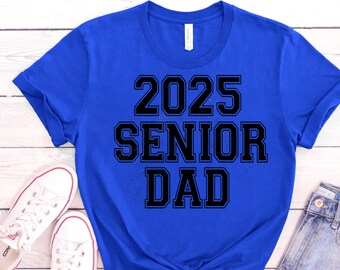 May include: A royal blue t-shirt with black text that reads "2025 Senior Dad".