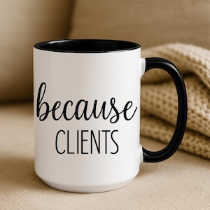 May include: White ceramic mug with a black interior, handle, and the words "because CLIENTS" in black script. The mug is on a neutral background.