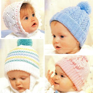 May include: Four knitted baby hats in various styles and colors. One is white with a pink trim, another is light blue with a pom-pom, a third is white with blue and yellow stripes, and the last is pink with floral details.