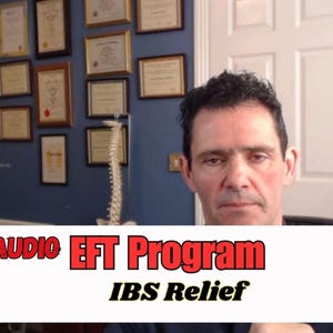 May include: A man in a white shirt is talking to the camera. He is in an office with a blue wall and a white door. The text on the screen says "Audio EFT Program IBS Relief".