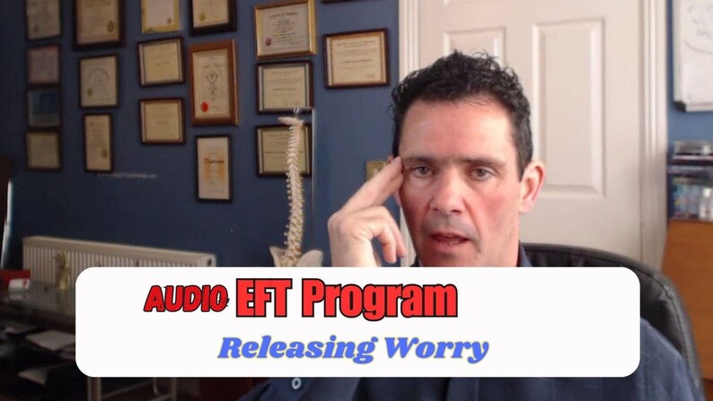 May include: A man in a blue shirt is the focus of this image, with the text "AUDIO EFT Program Releasing Worry" in a white and red banner. The background includes framed certificates and a model of a spine.