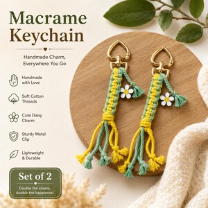 May include: A set of two macrame keychains featuring yellow and sage green cotton threads knotted in a repeating pattern. Each keychain includes a gold-toned heart-shaped metal clip and a small white daisy charm with a yellow smiley face center.