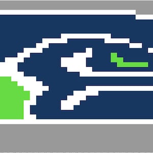 May include: Pixelated graphic of a stylized bird head in navy blue, white, and green, set against a gray background. The bird's eye is green, and the beak is white. The design is reminiscent of a sports team logo.
