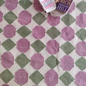 May include: Three self-help books on a white and green patterned rug. The books are titled "The Power of Your Subconscious Mind", "How to Use Your Healing Power", and "Think and Grow Rich".
