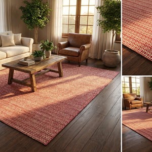 May include: A large, rectangular red area rug with a geometric pattern. The rug is placed in a living room setting with a sofa, chairs, and a wooden coffee table. The rug's dimensions are not specified.