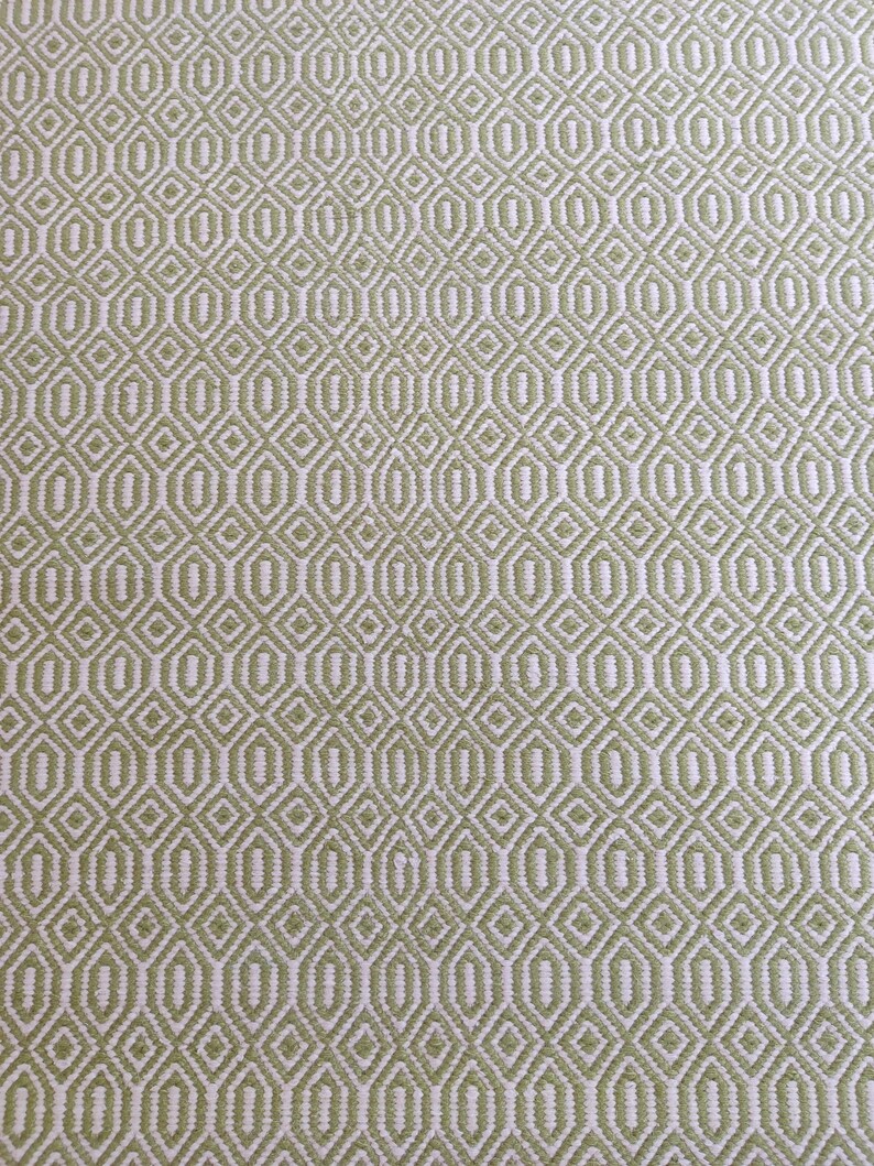 May include: A green and white woven fabric with a geometric diamond pattern.
