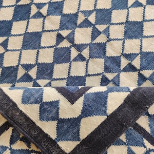 cotton wool rug, handwoven with a striking geometric design. Perfect for modern, coastal, or transitional interiors, this flatweave rug blends the softness of wool with the durability of cotton. Ideal for living rooms, bedrooms, or offices, it brings timeless style and comfort. Lightweight, reversible, and easy to maintain. Custom sizes available for designers and home decorators.