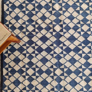 cotton wool rug, handwoven with a striking geometric design. Perfect for modern, coastal, or transitional interiors, this flatweave rug blends the softness of wool with the durability of cotton. Ideal for living rooms, bedrooms, or offices, it brings timeless style and comfort. Lightweight, reversible, and easy to maintain. Custom sizes available for designers and home decorators.