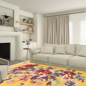 K&ouml;nnte beinhalten: Ein gelber Teppich mit einem farbenfrohen, abstrakten Muster. Der Teppich befindet sich in einem Wohnzimmer mit einem wei&szlig;en Sofa und einem Kamin.