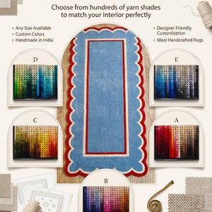 May include: A customizable rug with a light blue center, red border, and scalloped edge. The image includes color swatches and text that reads "Customize this rug in your favorite colors." It also states the rug is handmade in India.