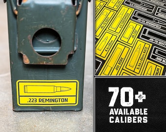May include: A green metal ammunition box with a yellow sticker displaying a .223 Remington bullet graphic. Additional images show various caliber labels and the text "70+ AVAILABLE CALIBERS" on a black background. The box has a metal latch.
