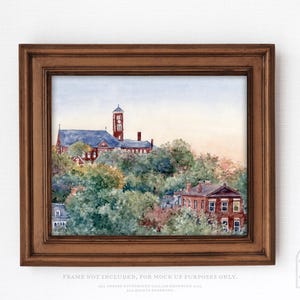 May include: Watercolor painting of a building with a blue roof and a tower, surrounded by trees and other buildings. The artwork is framed in a brown wooden frame. The text at the bottom reads "FRAME NOT INCLUDED, FOR MOCK UP PURPOSES ONLY."