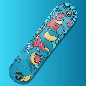 May include: A blue skateboard deck featuring a graphic of three blue and yellow Pokemon characters. The characters are stacked, with the smallest at the top and the largest at the bottom. All characters face the viewer. The deck has a blue background with white and yellow swirls. A black and white logo in the bottom left corner reads "DECKSMITH DESIGNS".