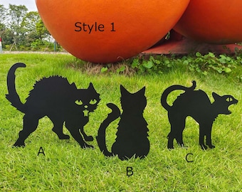 May include: Three black metal cat silhouettes in different poses. The silhouettes are standing on a green grassy lawn. The text "Style 1" is visible in the background.