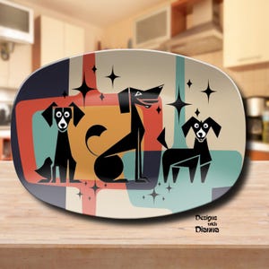 May include: Oval ceramic platter with a retro design featuring three stylized black dogs against a backdrop of geometric shapes in orange, teal, and beige. The platter has a glossy finish and includes the text "Designs with Dianna".