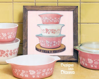 May include: A collection of pink and white vintage Pyrex bowls with a leaf and berry design. The image includes a framed print of stacked bowls, and individual bowls with lids. The text "Designs with Dianna" is visible.