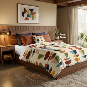 May include: A bed featuring a cream-colored duvet cover with a repeating pattern of multicolored semicircles in shades of blue, green, orange, and brown. The bed includes solid dark blue and rust-colored pillows, plus a decorative accent pillow.