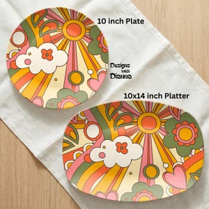 Puede incluir: Un plato de 25 cm y una fuente de 25x36 cm con un dise&ntilde;o retro. Los platos presentan un patr&oacute;n colorido con un sol, nubes, flores y arco&iacute;ris en tonos naranja, rosa, amarillo y verde. El texto "Designs with Dianna" es visible.