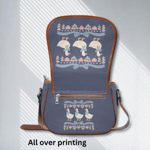 Cute goose purse with brown trim and adjustable strap, perfect for weekend markets or school