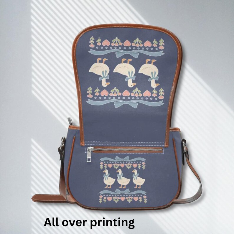 Cute goose purse with brown trim and adjustable strap, perfect for weekend markets or school