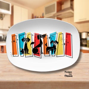 May include: White oval serving platter with a retro design featuring black dog silhouettes against colorful vertical rectangles. The design includes orange, blue, yellow, and red elements with starburst accents. The platter has the text "Designs with Dianna".