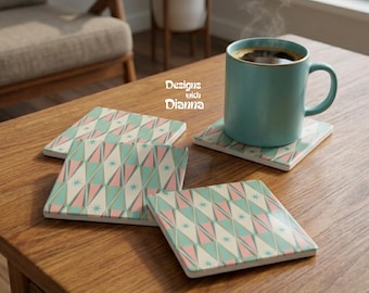 May include: A set of three square coasters featuring a geometric pattern of teal, pink, and cream triangles with small starburst accents, accompanied by a teal ceramic mug filled with a dark beverage, with the text Designs with Dianna visible.