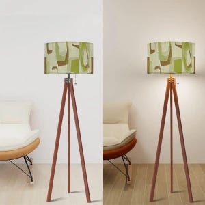 Modern tripod floor lamp with Mid Century geometric drum lampshade in earthy olive green colors.