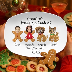 May include: A white ceramic plate with the text "Grandma's Favorite Cookies" and the names Isaac, Hannah, Charlie, and Mabel. The plate features gingerbread people and animal illustrations. The plate also has the text "We Love you! 2025".