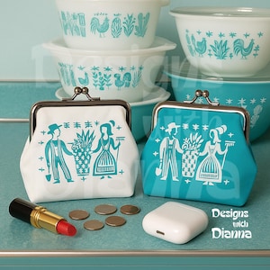 May include: Two coin purses, one white and one teal, with a metal clasp. Each purse features a teal illustration of a man and woman with gardening tools. A tube of lipstick, coins, and a white wireless earbud case are in front of the purses. Vintage Pyrex bowls are in the background.